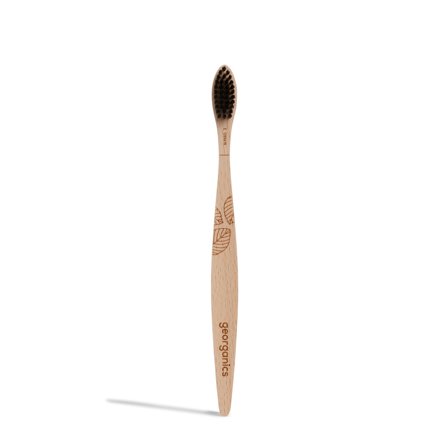 Georganics beechwood soft toothbrush with black bristles on a white background