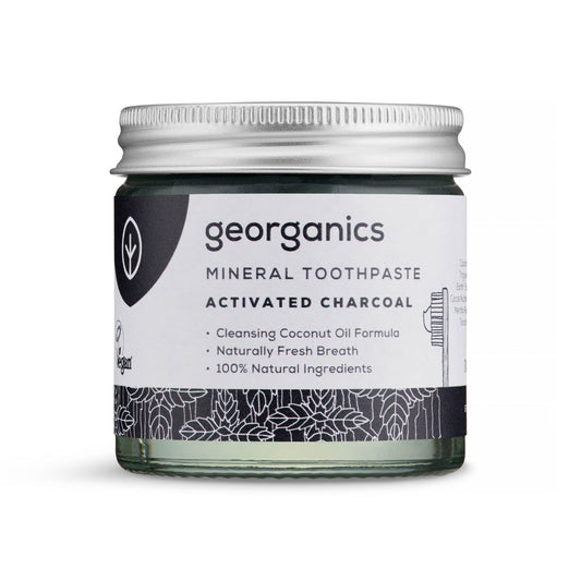Georganics activated charcoal toothpaste jar on a white background
