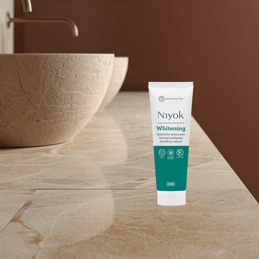 Niyok Whitening natural toothpaste tube on a bathroom counter