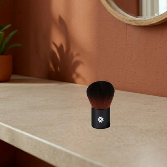 Black super kabuki makeup brush with brown bristles on a mediterranean background