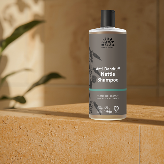 Urtekram Anti-Dandruff Nettle Shampoo bottle in a bathroom