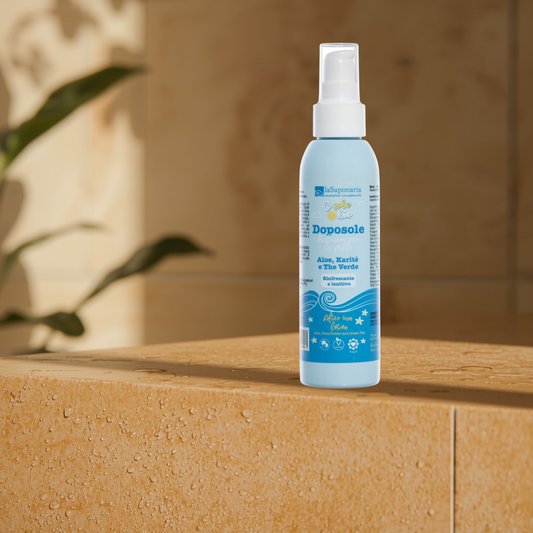 La Saponaria after sun body lotion spray bottle on a stone surface with a blurred background