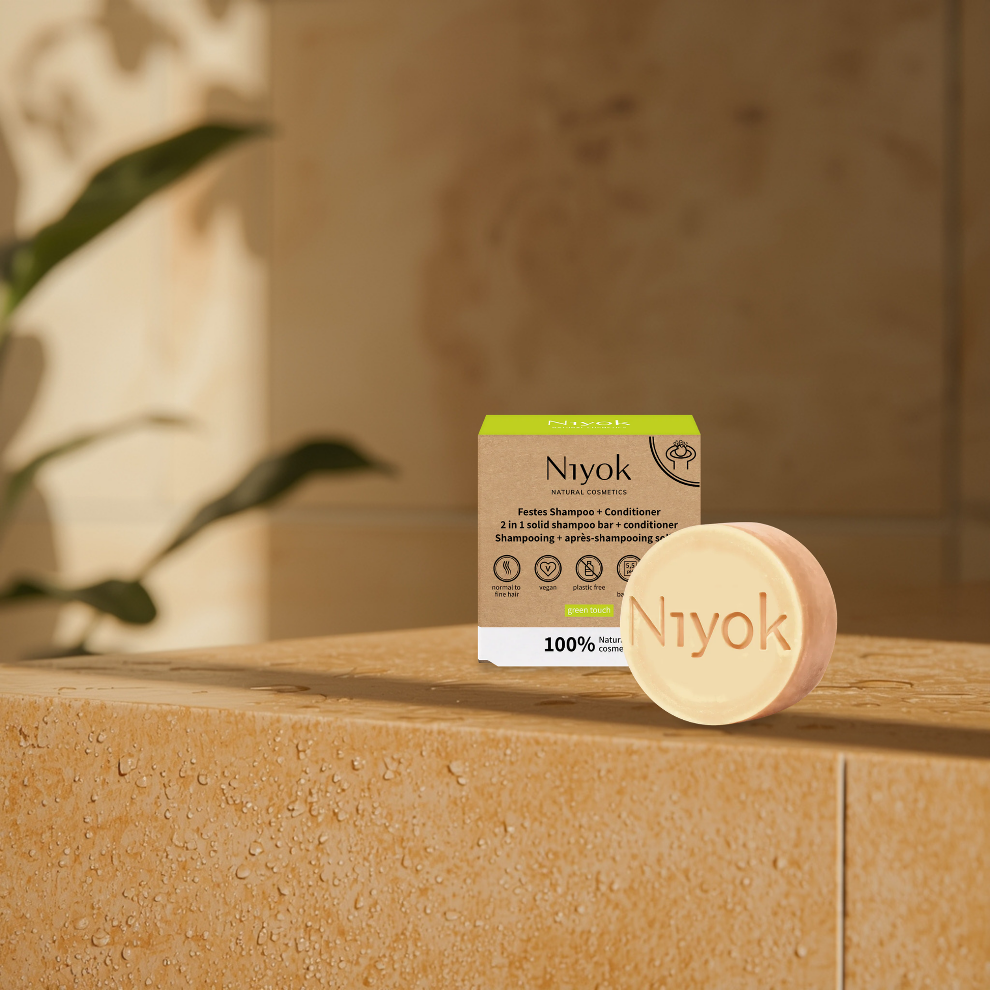 Niyok shampoo and conditioner bar and packaging on a stone surface with a blurred background