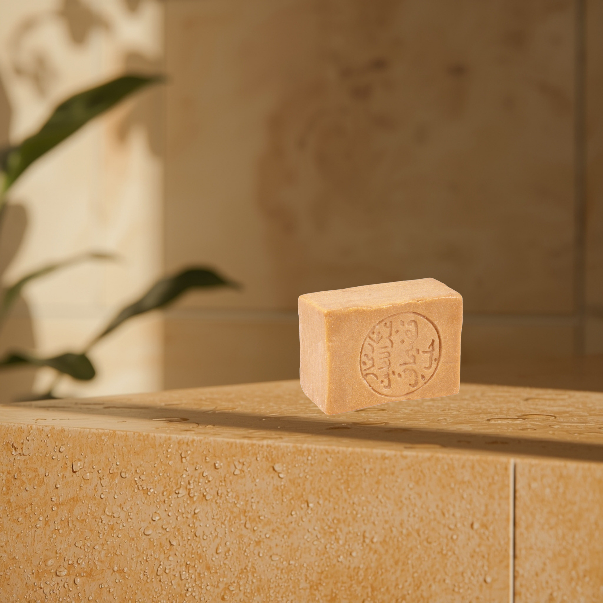 Aleppo 12% bar soap on a stone surface with a blurred background