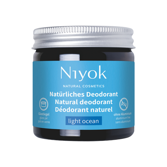 Niyok natural deodorant light ocean jar with blue label on a white background