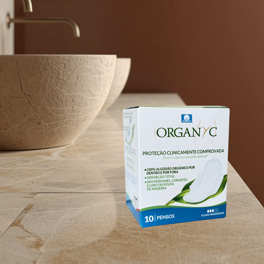 Organyc moderate pads on a bathroom counter with a sink in the background