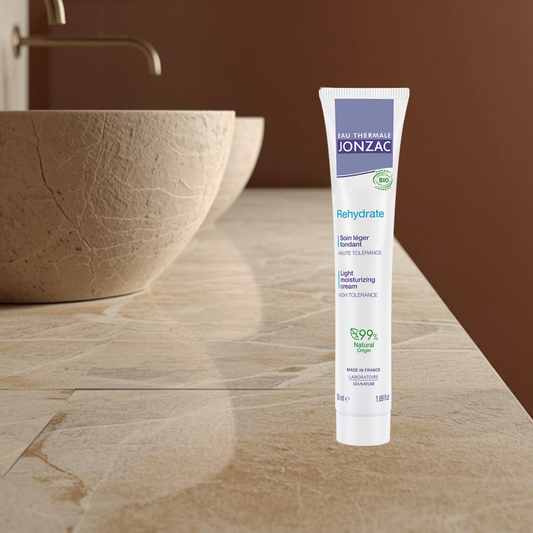Jonzac light moisturizer tube on a bathroom counter with a sink in the background