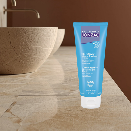 Tube of Eau Thermale Jonzac cleansing gel on a bathroom counter with a sink in the background
